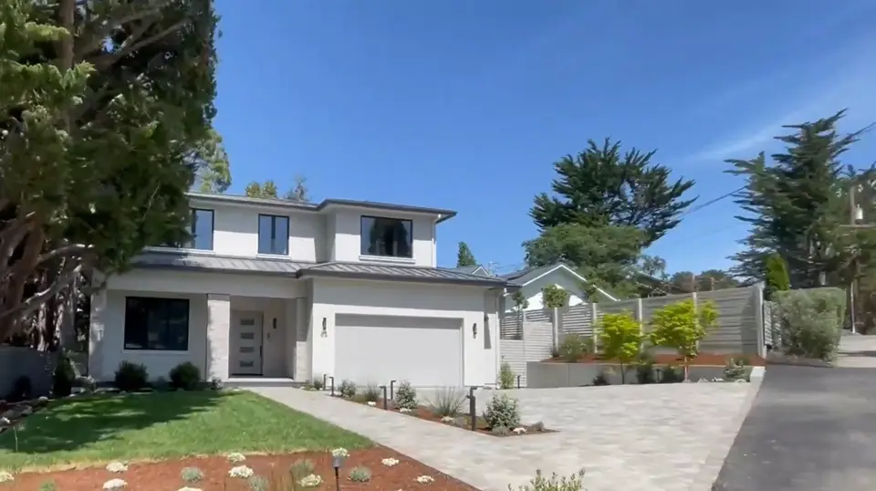 Front yard after landscaping with lawn, planting and a clean driveway edge