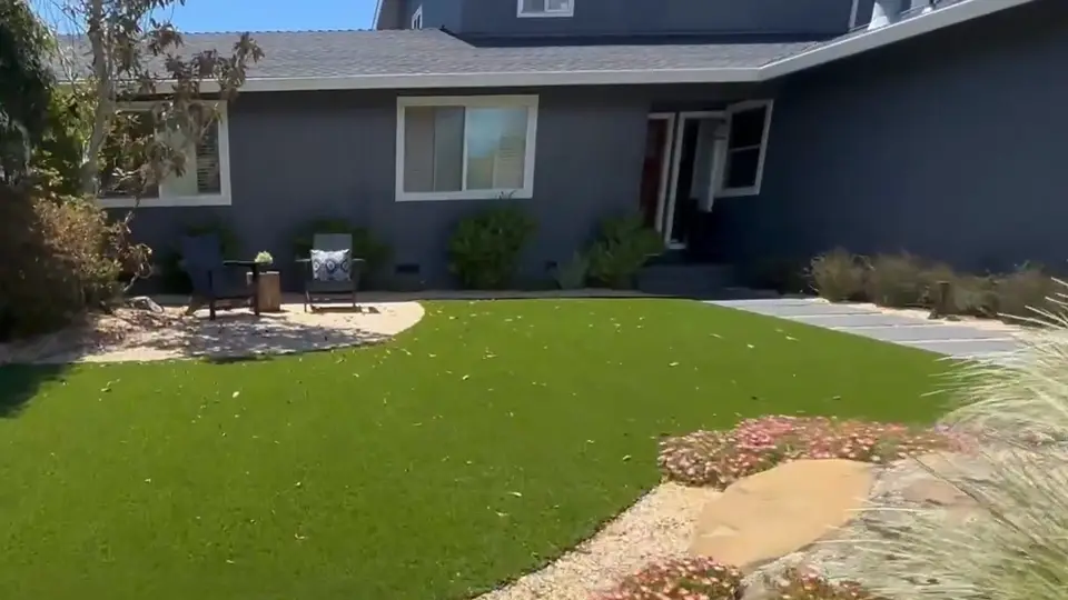 Front yard with a stone walkway, boulders and drought-tolerant landscaping