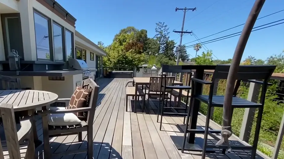 Hardwood deck with an outdoor BBQ island and dining area