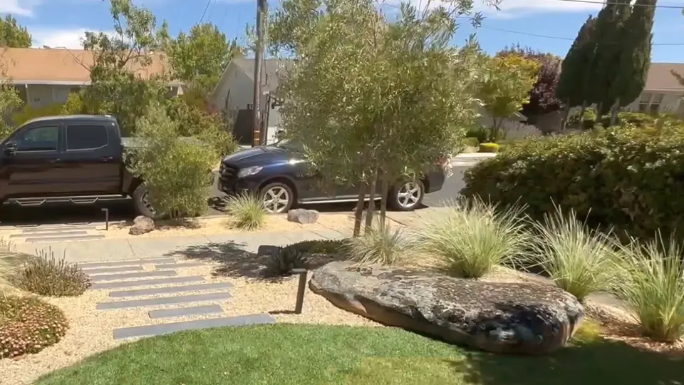 Natural stone stepping walkway through a landscaped front yard