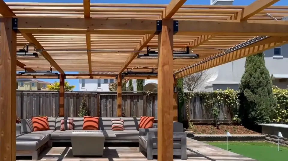 Wood pergola over a paver patio lounge with outdoor sofas